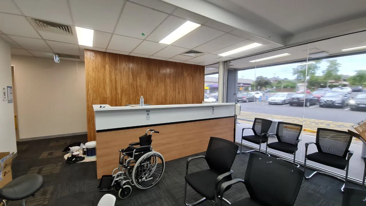 A clinic waiting room and reception desk