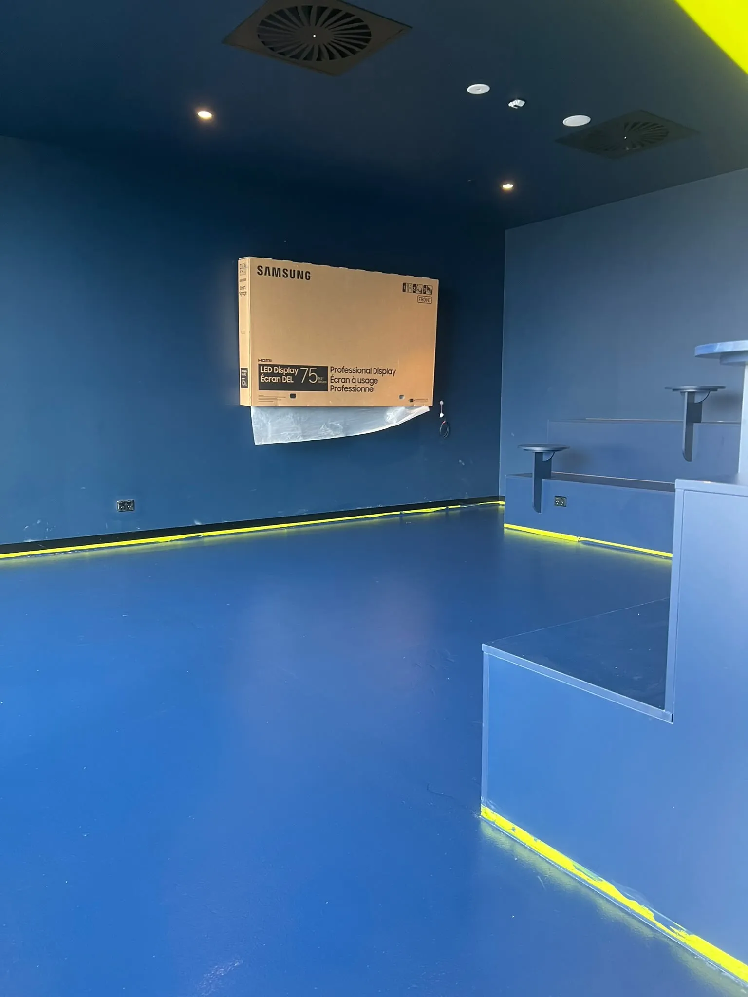 A blue commercial interior with a yellow reveal
