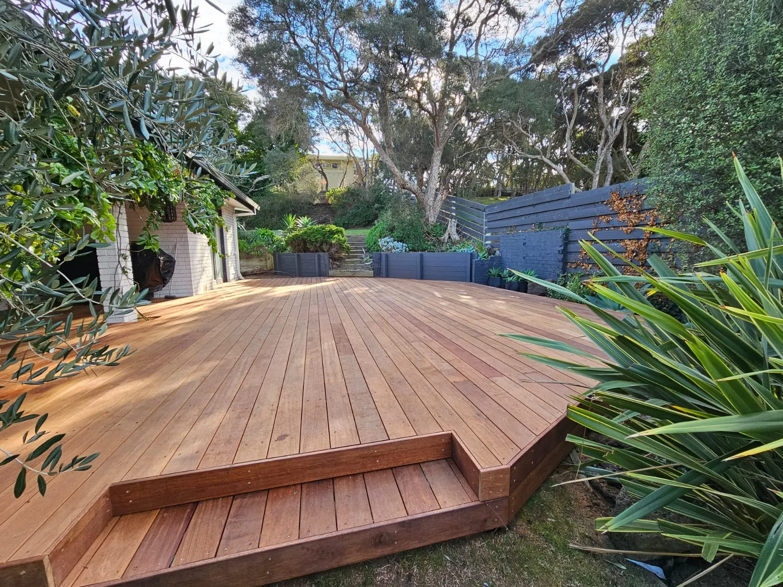 A newly stained wood deck in a garden