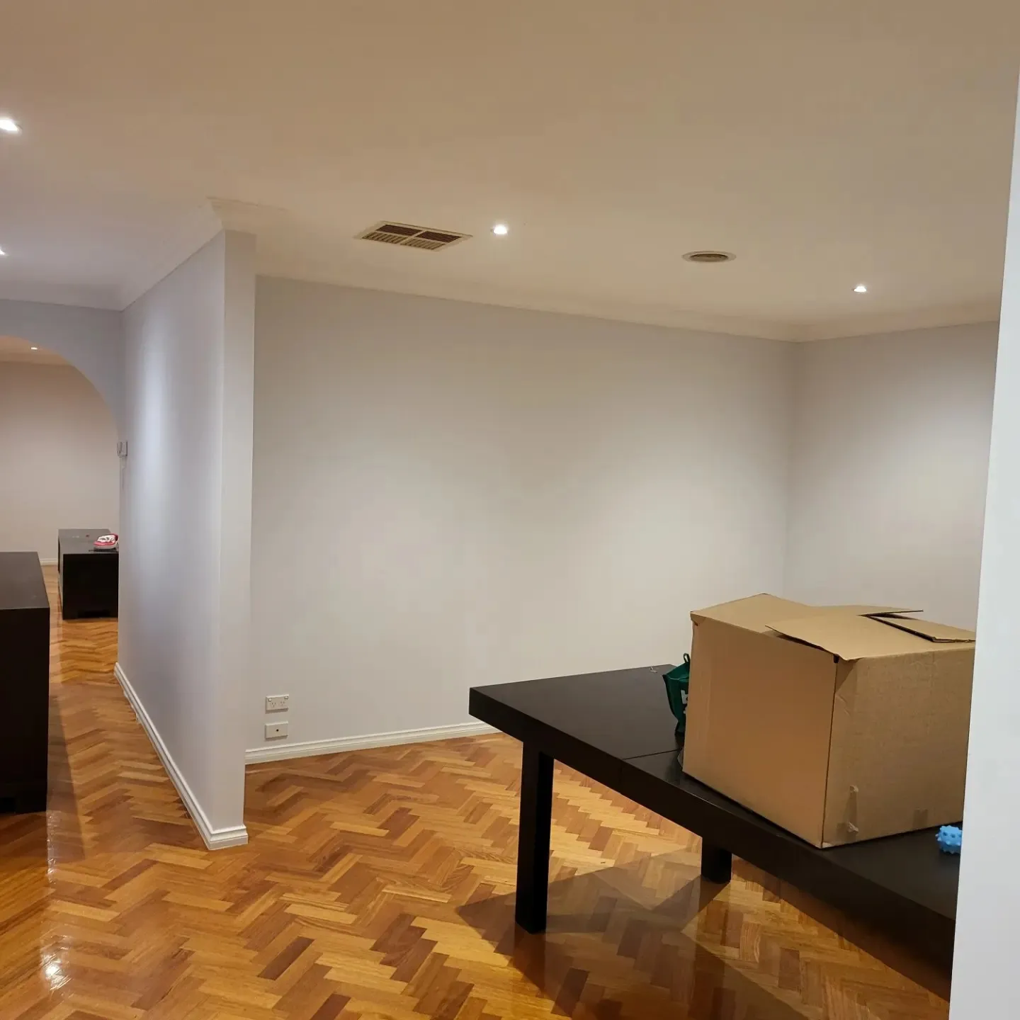 A room with fresh white walls and a parquet floor