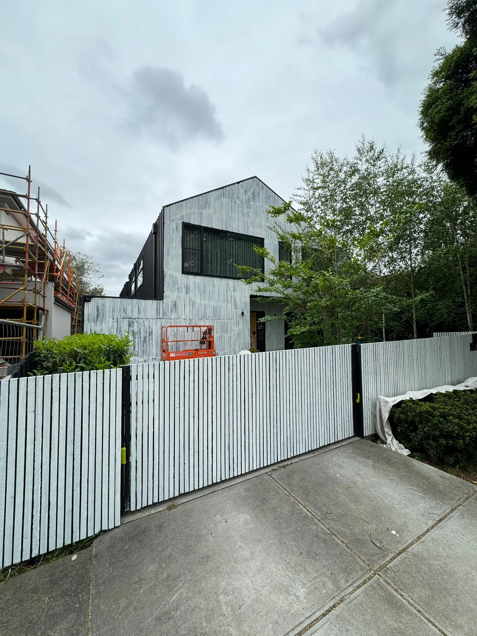 A painted fence and gate in front of a house