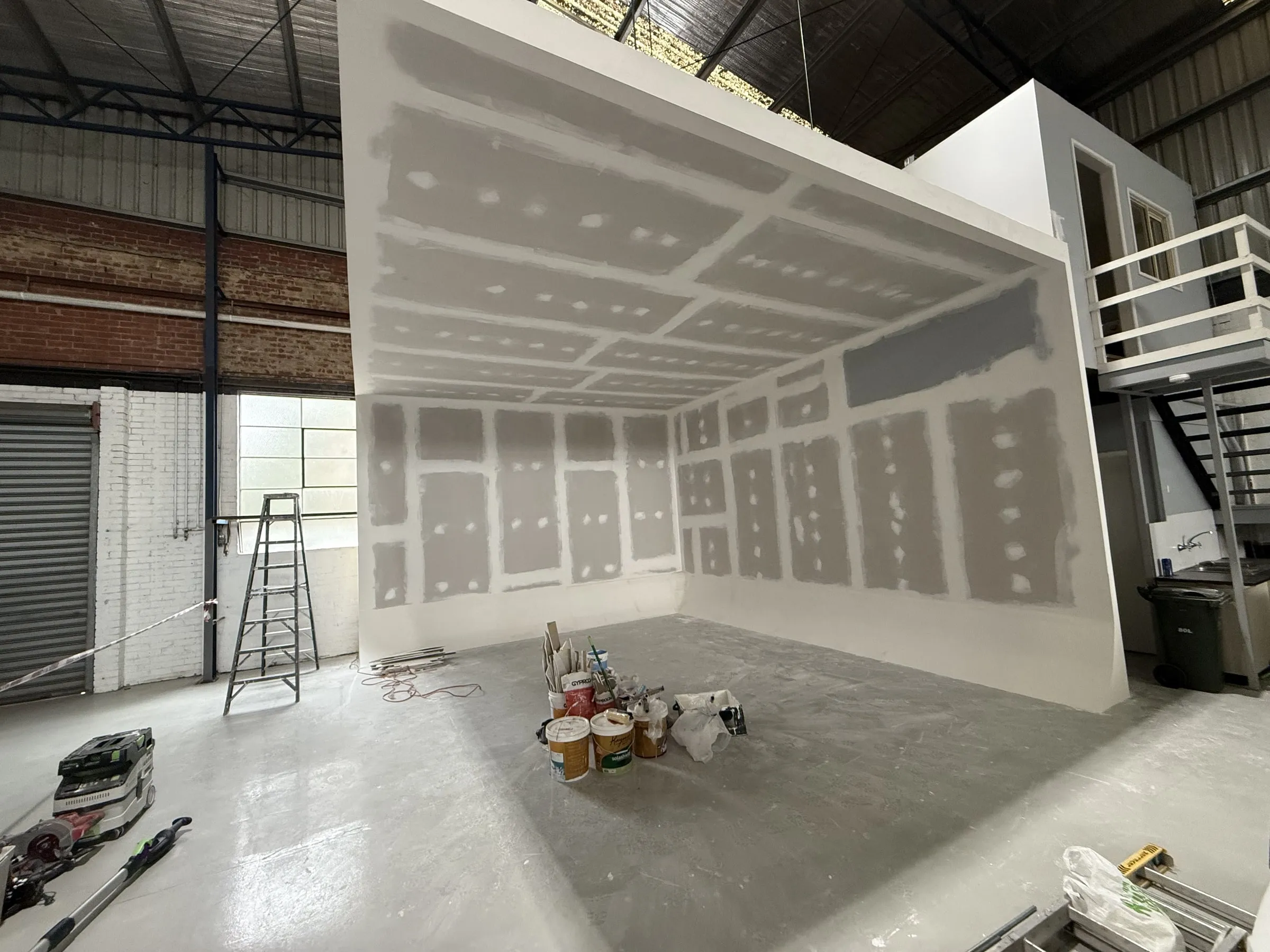 Drywall joints taped and filled on a warehouse wall