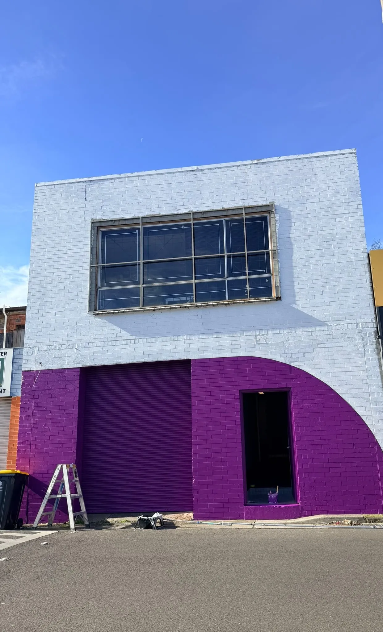 A storefront painted white and purple